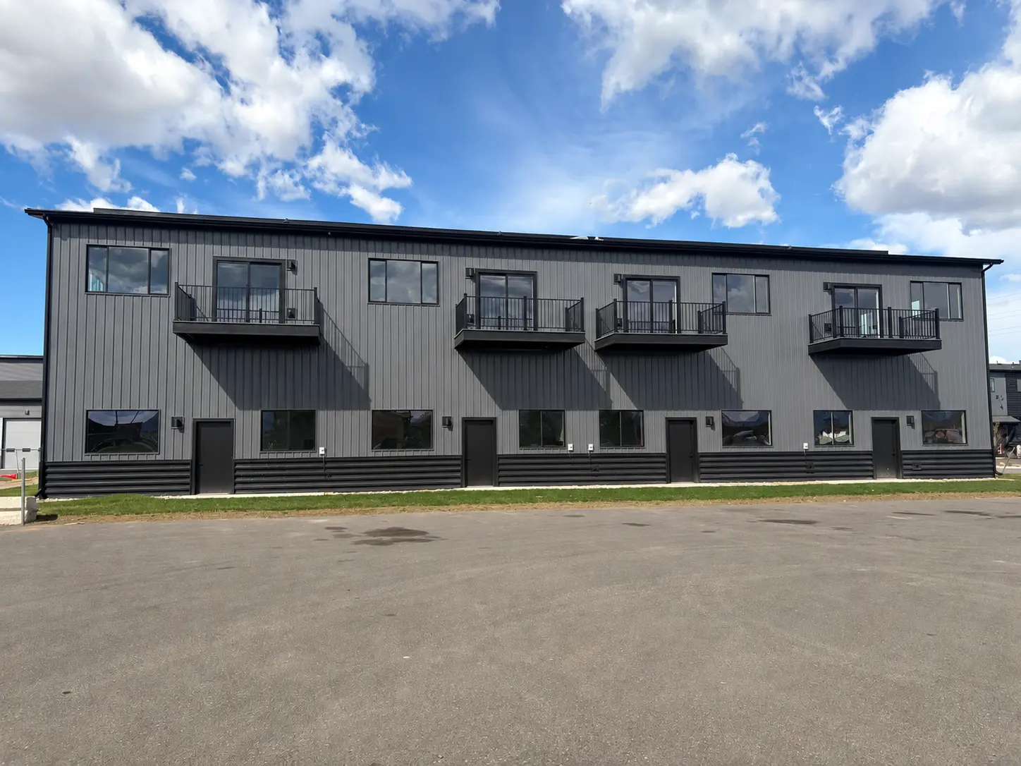 Finished two-story commercial metal building exterior with balconies