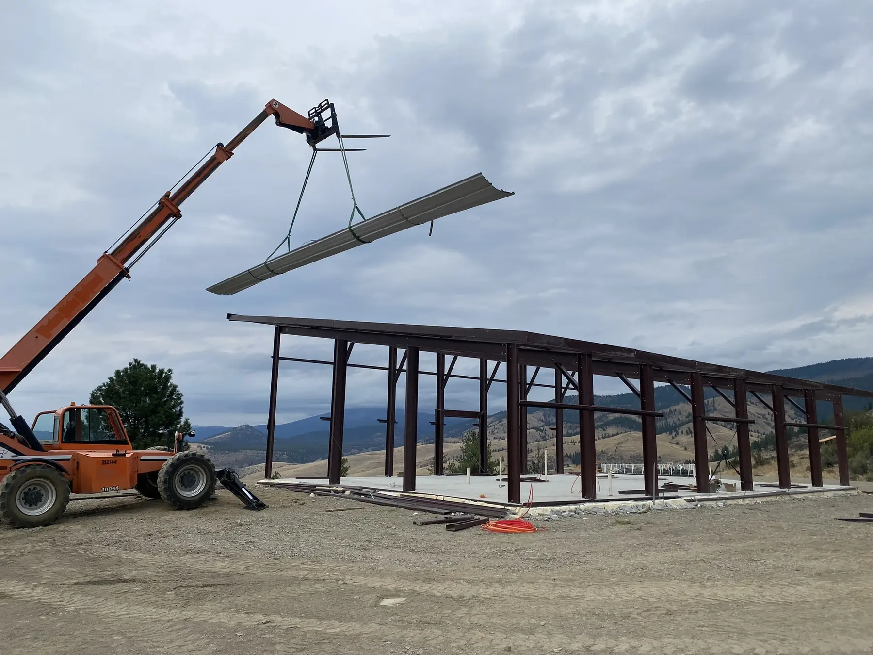 Telehandler positioning material during steel building erection