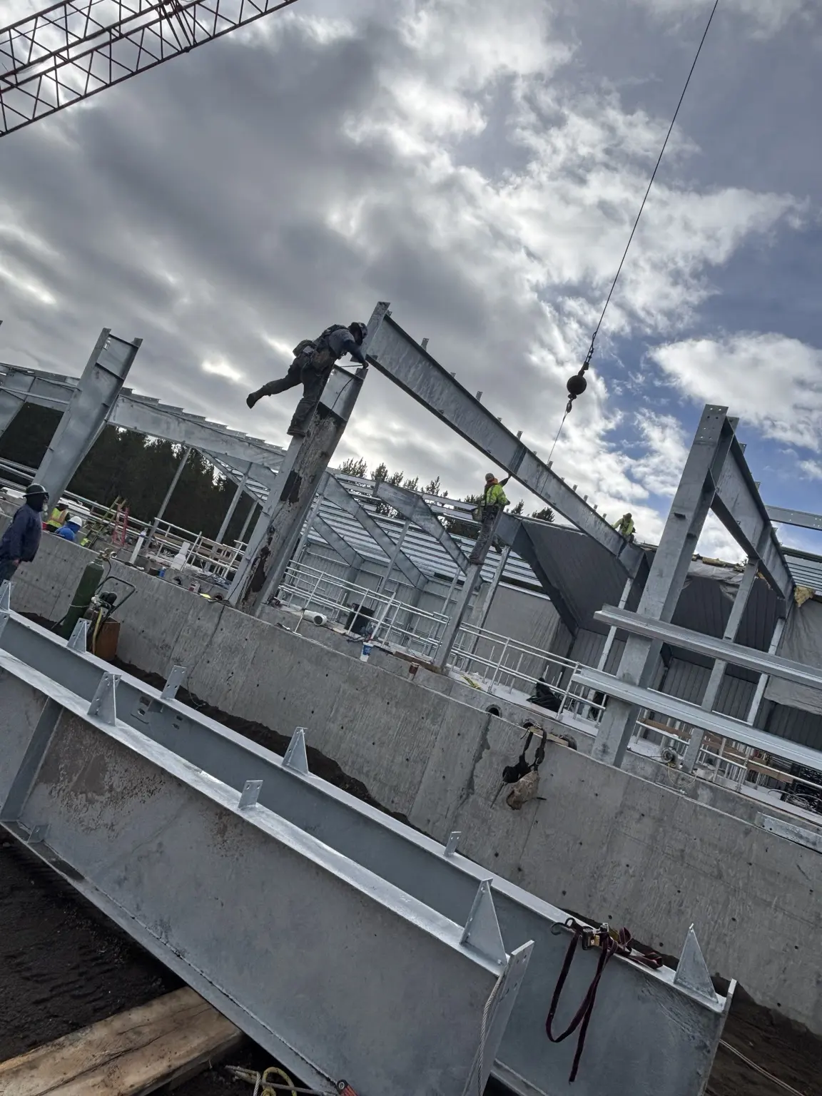 Ironworkers setting structural steel with a crane